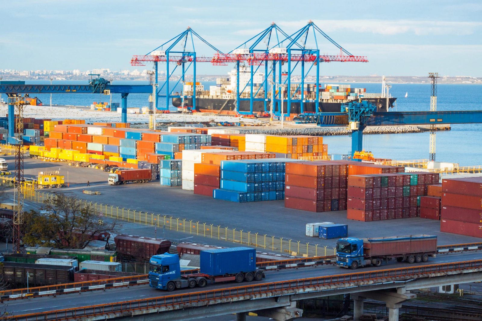 Trucks moving containers through a terminal yard